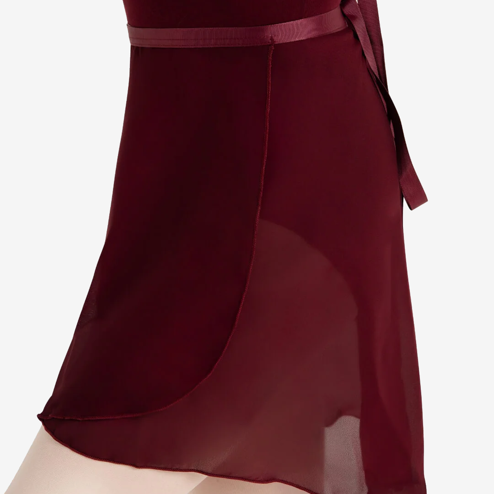 
                      
                        A side view of a burgundy wrap skirt over a burgundy leotard and pink tights against a light grey background.
                      
                    