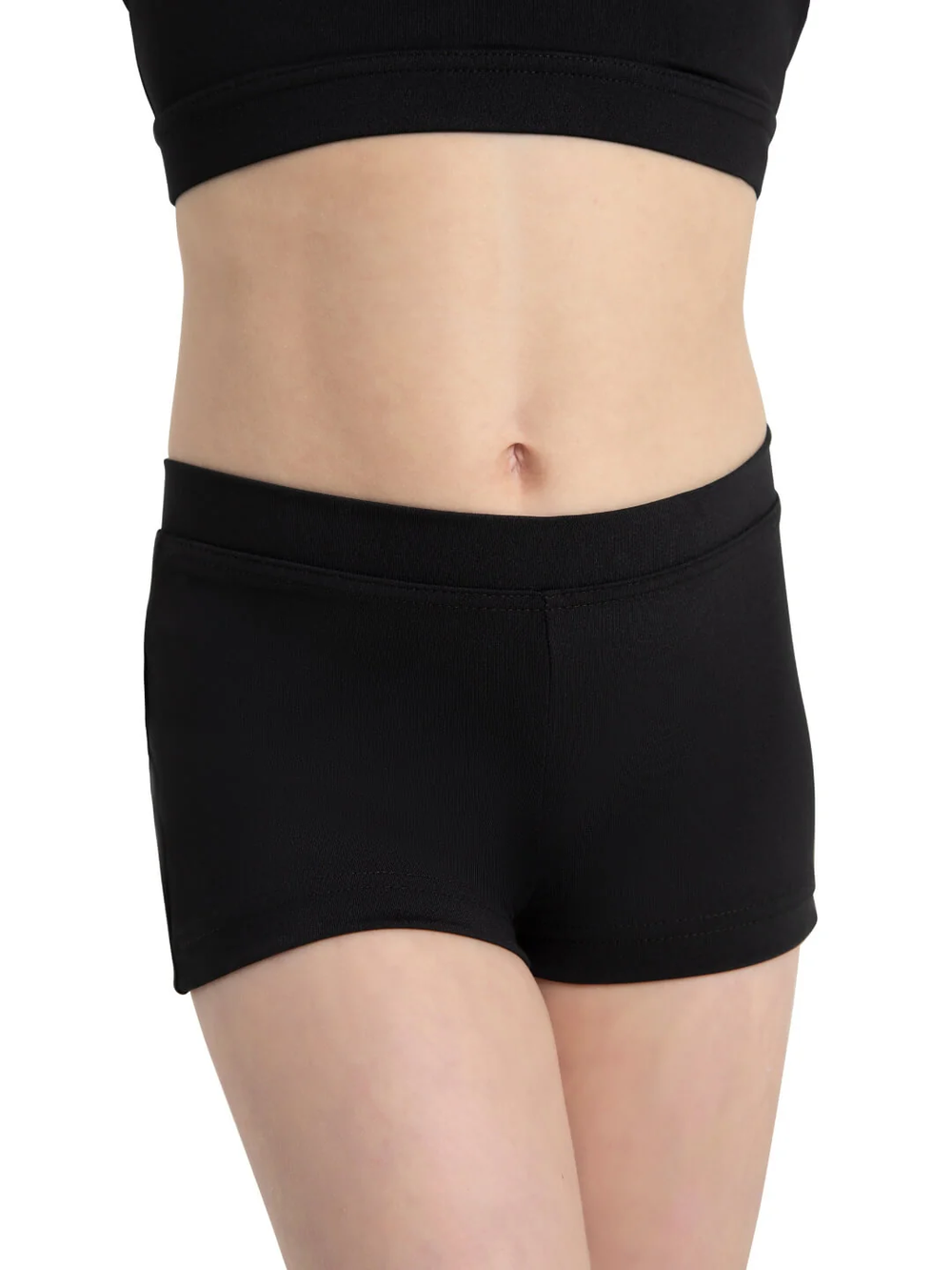 A close-up of a child's torso wearing a pair of black dance shorts.